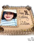 Extra large sponge cake with edible cake topper of a photo of a child and 'Happy 18th Birthday William' text.