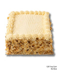 A square carrot cake with cream cheese frosting and almonds on the side of the cake, shown on a white background with small text in the bottom right reading '1/8 Tray Carrot Cake No Decorations'.