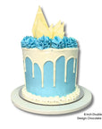 Blue and white drip birthday cake with decorative elements on a white background