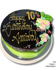 Chocolate mud birthday cake with gold text and floral decorations on a white background