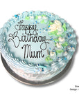 Egg & diary free birthday cake with 'Happy Birthday Mum' text and floral decorations on a white background