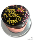 Chocolate mud birthday cake with 'Happy Birthday Angel' text on a white background and jelly design