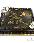Extra large chocolate birthday cake with gold writing and decorative elements on a white background