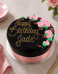 Chocolate mud birthday cake for female with pink chocolate wrap and piped flowers
