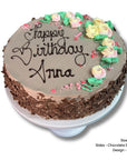 Chocolate sponge birthday cake with 'Happy Birthday Anna' on a white background