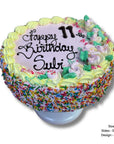 Colorful birthday cake with sprinkles and flowers on a white background