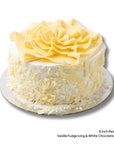 Red Velvet Birthday Cake with white icing and white chocolate scrolls