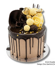 An 8-inch double height chocolate drip cake with chocolate frosting, decorated with dark chocolate and white chocolate swirls, chocolate pearls, and gold sprinkles, shown on a silver cake board against a white background.