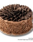 8 Inch Red Velvet Cake with Chocolate Icing, Chocolate Shavings and Chocolate Scrolls on top. 