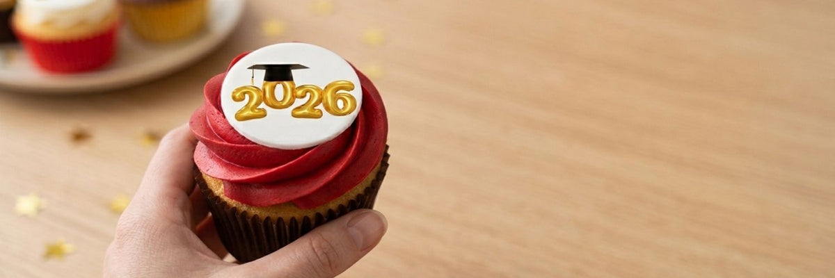 Hand holding a cupcake with class of 2026 icon