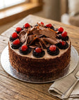 Black Forest cake with chocolate shards and cherries on wooden table