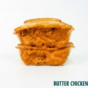 Two stacked butter chicken pie in a golden-brown sauce, shown on a white background with the text 'BUTTER CHICKEN' in the bottom right corner.
