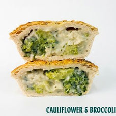 Two halves of a baked pie or pastry cut open to show a filling of broccoli and cauliflower with melted cheese, stacked vertically on a white background with the text 'CAULIFLOWER & BROCCOLI' at the bottom.