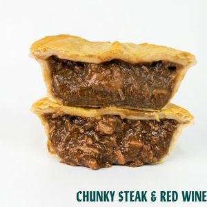 Two stacked beef pies with a chunky steak and red wine filling, shown on a white background with the text 'CHUNKY STEAK & RED WINE' at the bottom.