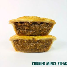 Two halves of a cut pie or mince steak with a thick, textured brown curry filling and golden-brown crust, stacked on a white background with the text 'CURRIED MINCE STEAK' at the bottom.