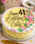 Gluten free pale yellow chocolate cake with piped flowers and with piping