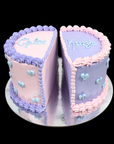 Two-tiered cake with two name written on top, one side pink and one side purple