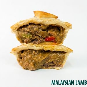 Two stacked halves of a golden-brown flaky pastry pie filled with a brownish-green lamb and vegetable mixture, shown on a white background with the text 'MALAYSIAN LAMB' in the bottom right corner.