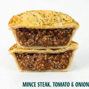 Two stacked mini pies filled with minced steak, tomato, and onion, shown on a white background with the text 'MINCE STEAK, TOMATO & ONION' at the bottom.