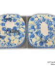 Cake shaped into number 90 with blue and white flowers and 'Happy Birthday' text on a white background.