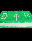 Cake designed to look like a sports field with green grass and white lines on a black background