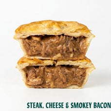 Two stacked halves of a baked steak pie with a golden flaky crust and a savory meat filling, shown on a white background with the text 'STEAK, CHEESE & SMOKEY BACON' at the bottom.
